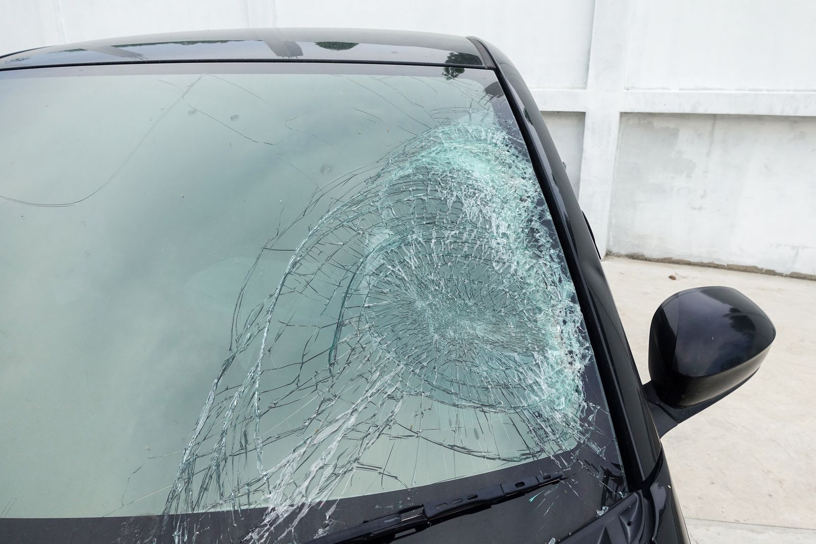 Large spreading windshield crack from an untreated rock chip on a car in Clinton, MD